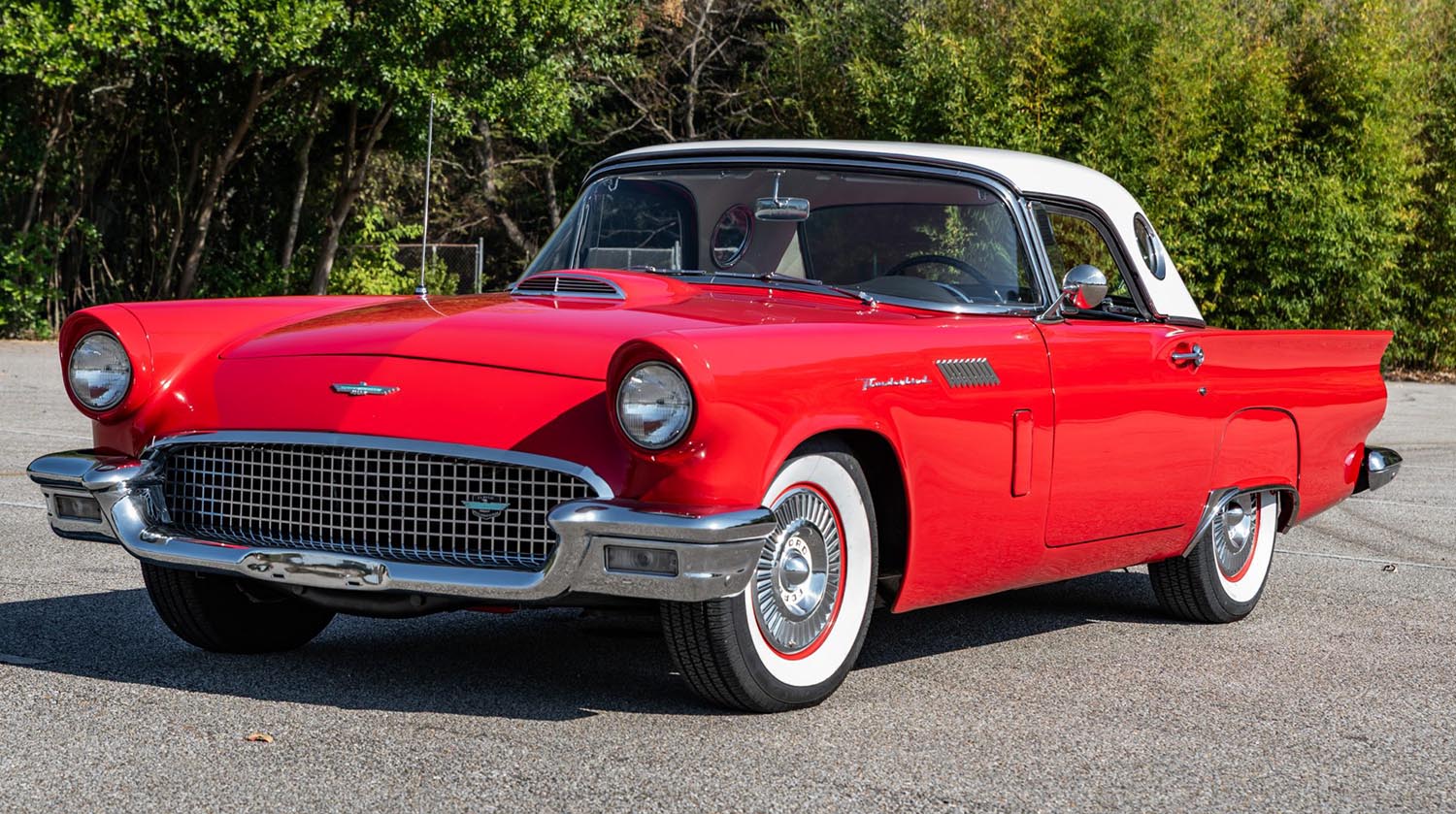 Red 1957 Ford Thunderbird with white porthole hardtop, front three-quarter view — same model shown for reference