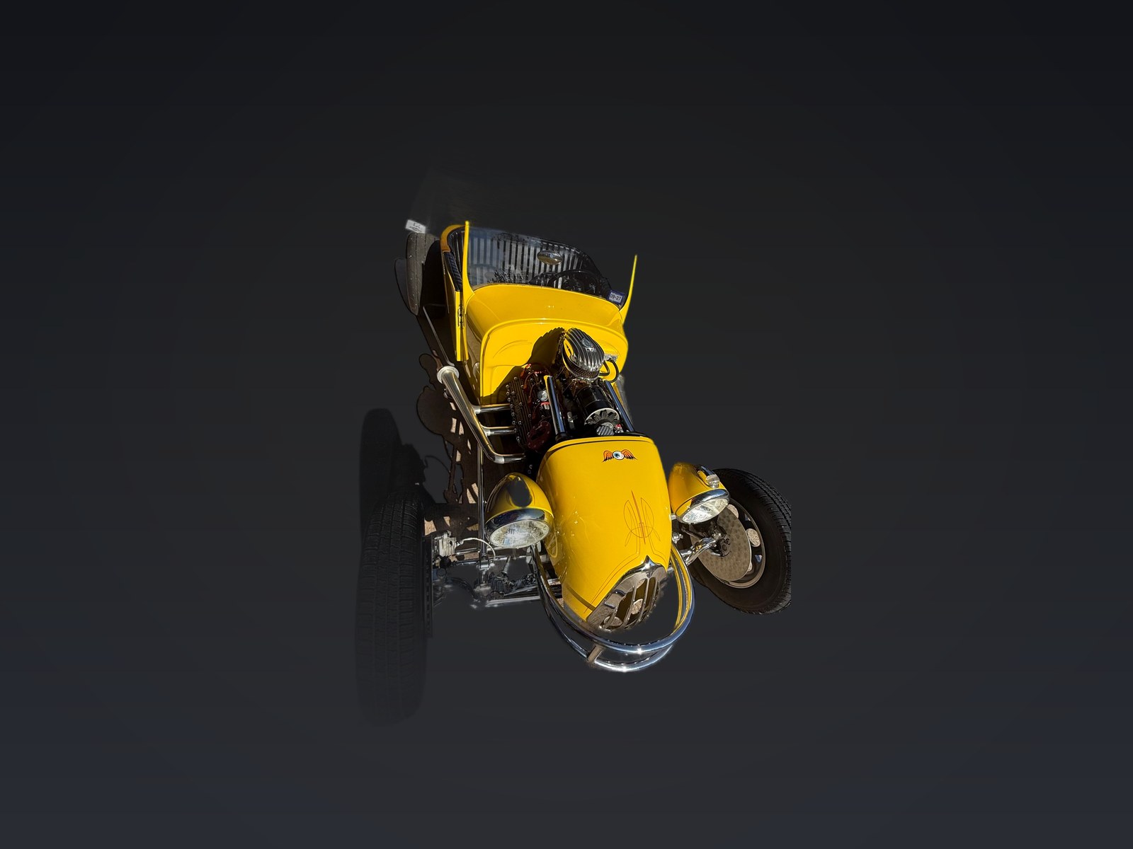 Yellow T-bucket hot rod, exposed chrome engine, open cockpit and wide rear tires
